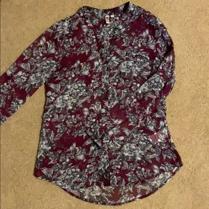 Maroon buttoned up blouse with button sleeves.